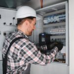 Elektrikas tikrina elektros skydelį